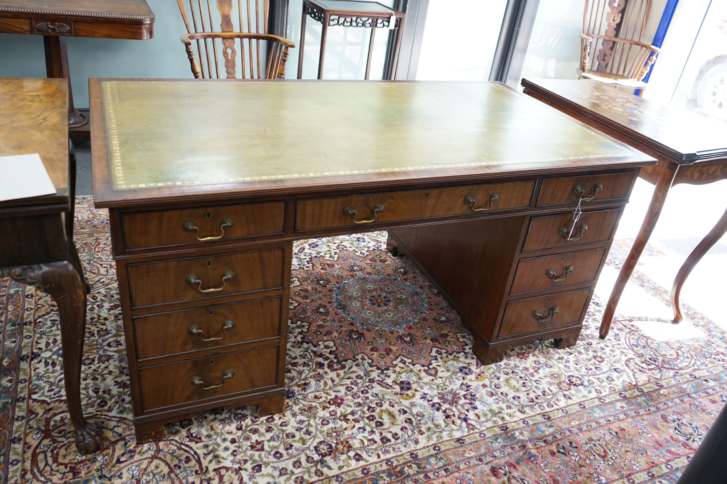 An early 20th century George III style mahogany pedestal desk, width 154cm depth 84cm height 74cm